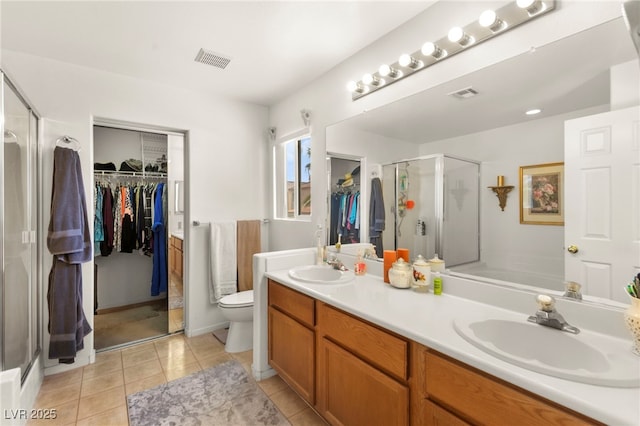 9522 Arrowhead Falls Ct, Las Vegas, NV 89148 - bathroom featuring tile patterned flooring, a stall shower, double vanity, and a spacious closet
