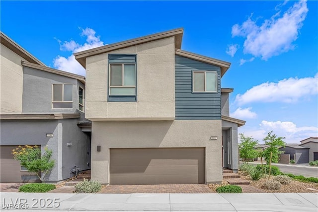 3192 Timorasso Ave, Henderson, NV 89044 - contemporary home with stucco siding, an attached garage, and decorative driveway