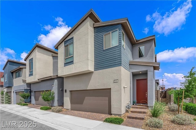 3192 Timorasso Ave, Henderson, NV 89044 - view of front of property with a garage, stucco siding, and decorative driveway