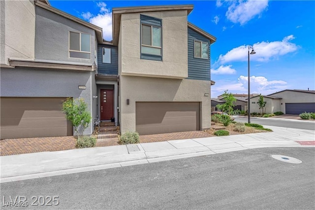 3192 Timorasso Ave, Henderson, NV 89044 - view of front of home featuring an attached garage, stucco siding, and decorative driveway