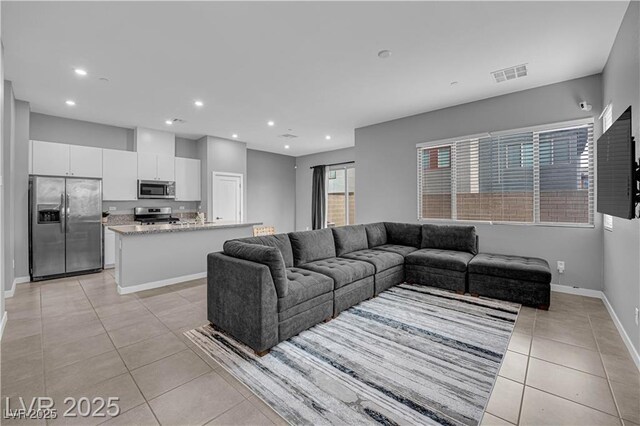 3192 Timorasso Ave, Henderson, NV 89044 - living room with light tile patterned flooring, recessed lighting, and baseboards
