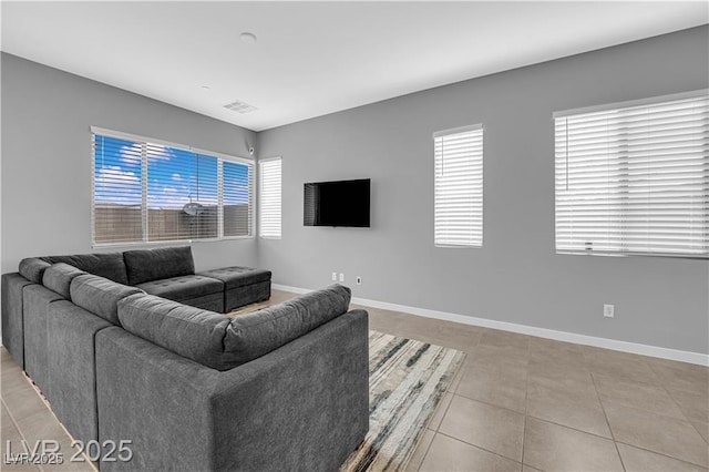 3192 Timorasso Ave, Henderson, NV 89044 - living area with healthy amount of natural light, light tile patterned floors, and baseboards