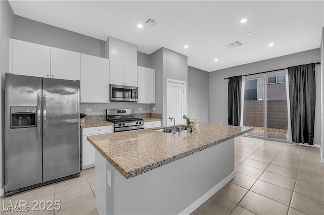 3192 Timorasso Ave, Henderson, NV 89044 - kitchen with appliances with stainless steel finishes, a sink, light tile patterned floors, a kitchen island with sink, and recessed lighting