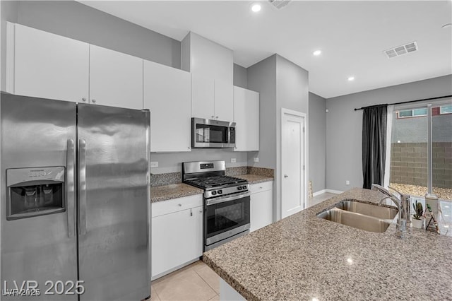 3192 Timorasso Ave, Henderson, NV 89044 - kitchen with appliances with stainless steel finishes, a sink, white cabinets, light stone counters, and recessed lighting