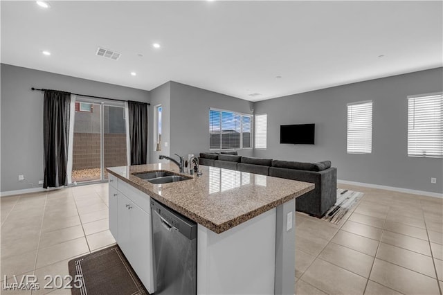 3192 Timorasso Ave, Henderson, NV 89044 - kitchen with stainless steel dishwasher, a sink, light tile patterned floors, a center island with sink, and light stone countertops
