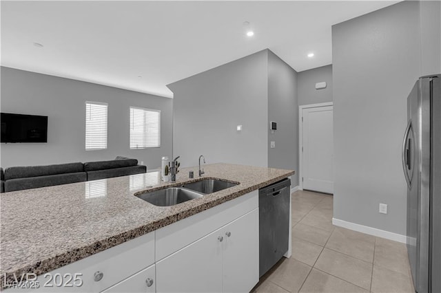 3192 Timorasso Ave, Henderson, NV 89044 - kitchen featuring dishwashing machine, freestanding refrigerator, a sink, white cabinetry, and light tile patterned floors
