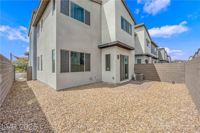 3192 Timorasso Ave, Henderson, NV 89044 - back of property with stucco siding, central air condition unit, a fenced backyard, and a patio area