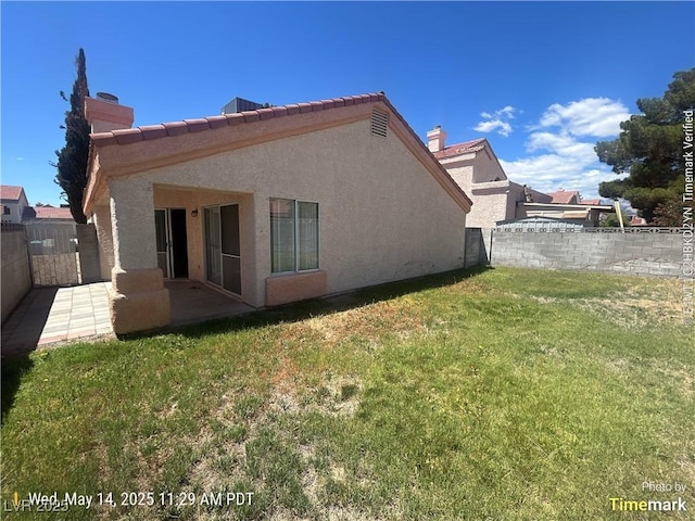 6512 Sterling Springs Pkwy, Las Vegas, NV 89108 - back of property with a patio area, stucco siding, a tiled roof, and a chimney