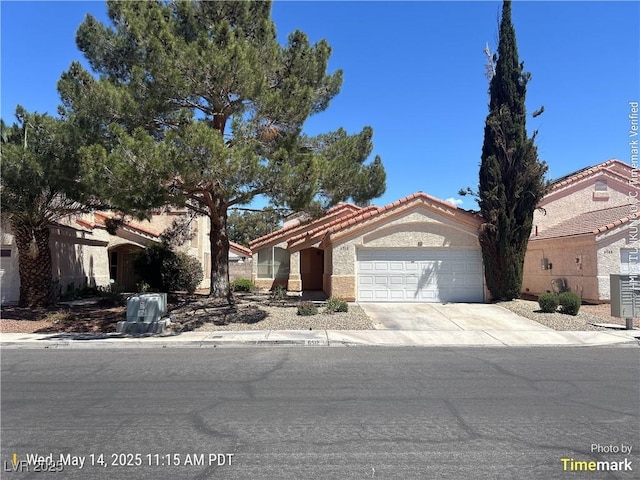 6512 Sterling Springs Pkwy, Las Vegas, NV 89108 - view of front of home with an attached garage, driveway, a tile roof, and stucco siding