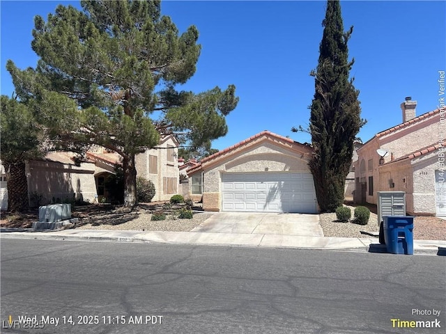 6512 Sterling Springs Pkwy, Las Vegas, NV 89108 - view of front facade featuring concrete driveway, an attached garage, and a tile roof