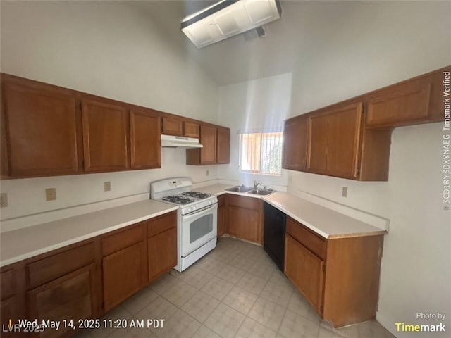 6512 Sterling Springs Pkwy, Las Vegas, NV 89108 - kitchen featuring white range with gas stovetop, under cabinet range hood, dishwasher, brown cabinetry, and high vaulted ceiling
