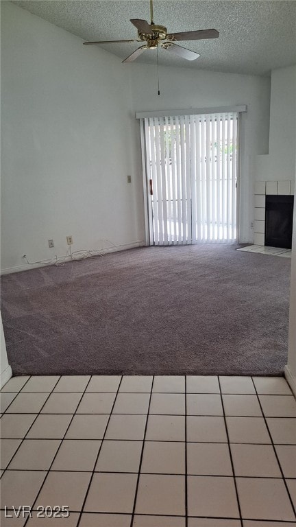 6512 Sterling Springs Pkwy, Las Vegas, NV 89108 - unfurnished living room with light colored carpet, a textured ceiling, ceiling fan, and a fireplace with flush hearth