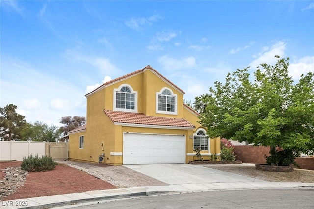 1117 Coral Crystal Ct, North Las Vegas, NV 89032 - mediterranean / spanish home with a tiled roof, a garage, fence, stucco siding, and driveway