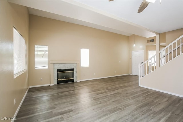 1117 Coral Crystal Ct, North Las Vegas, NV 89032 - unfurnished living room with ceiling fan, stairway, wood finished floors, baseboards, and a glass covered fireplace