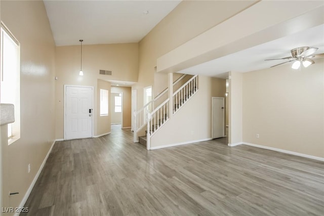 1117 Coral Crystal Ct, North Las Vegas, NV 89032 - entryway with stairs, wood finished floors, baseboards, ceiling fan, and high vaulted ceiling