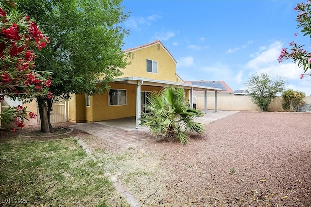 1117 Coral Crystal Ct, North Las Vegas, NV 89032 - rear view of property featuring a patio area, stucco siding, and a fenced backyard