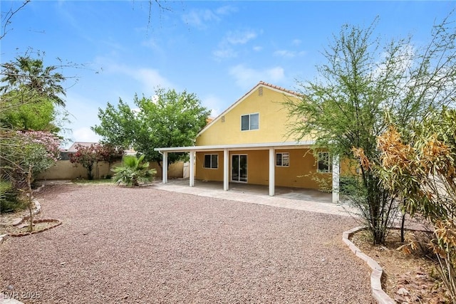 1117 Coral Crystal Ct, North Las Vegas, NV 89032 - back of property with stucco siding, a patio, and fence