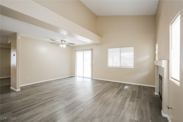 1117 Coral Crystal Ct, North Las Vegas, NV 89032 - unfurnished living room featuring a fireplace, wood finished floors, ceiling fan, and baseboards