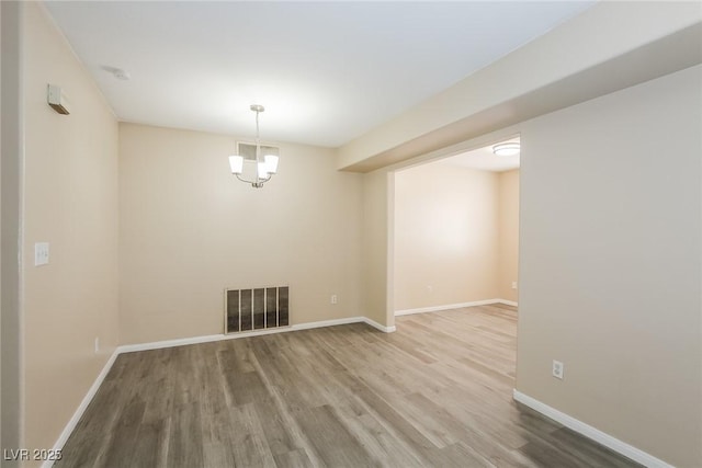 1117 Coral Crystal Ct, North Las Vegas, NV 89032 - spare room with wood finished floors, baseboards, and a chandelier