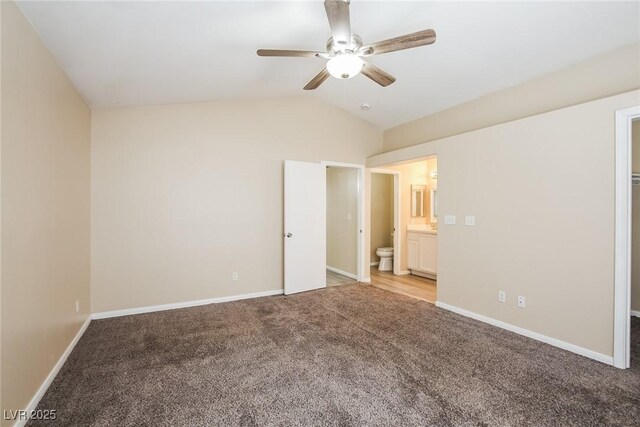 1117 Coral Crystal Ct, North Las Vegas, NV 89032 - unfurnished bedroom with light carpet, vaulted ceiling, ensuite bathroom, baseboards, and a ceiling fan