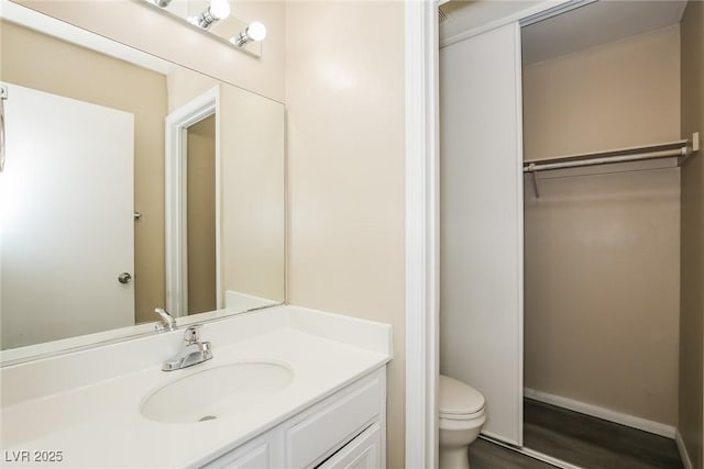 1117 Coral Crystal Ct, North Las Vegas, NV 89032 - bathroom featuring toilet, wood finished floors, vanity, and baseboards