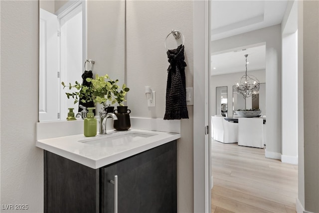 2601 Nevada Agave Ln, Las Vegas, NV 89138 - bathroom featuring wood finished floors, vanity, a chandelier, and baseboards