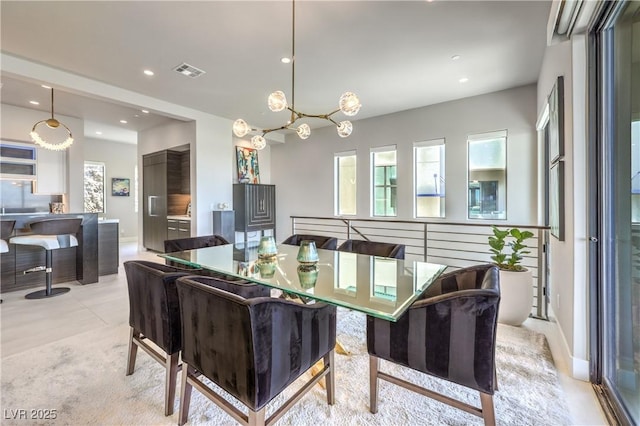 dining area with recessed lighting and a chandelier