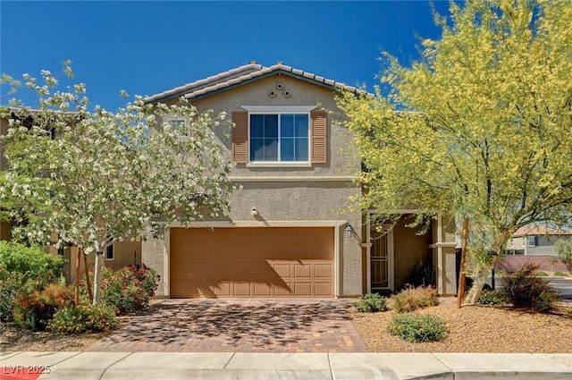 8164 Golden Cholla Ave, Las Vegas, NV 89179 - view of front of property featuring stucco siding, decorative driveway, and a garage