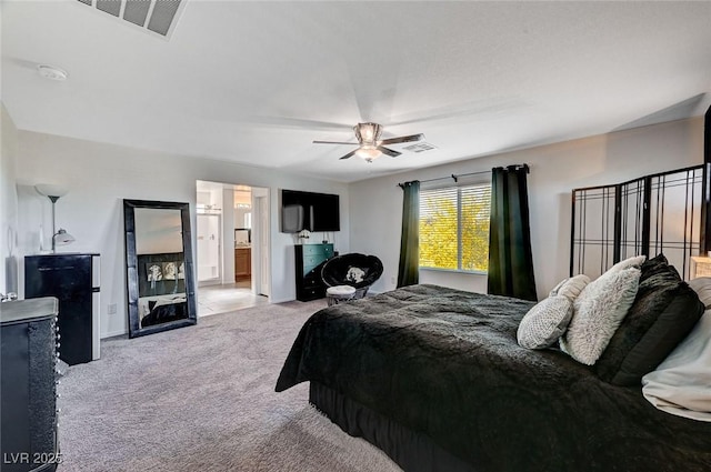 8164 Golden Cholla Ave, Las Vegas, NV 89179 - bedroom with light carpet, ceiling fan, baseboards, and ensuite bathroom