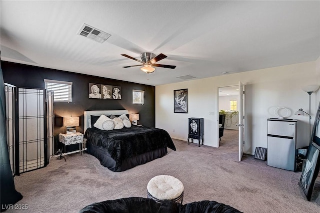 8164 Golden Cholla Ave, Las Vegas, NV 89179 - bedroom featuring refrigerator, carpet flooring, multiple windows, and ceiling fan