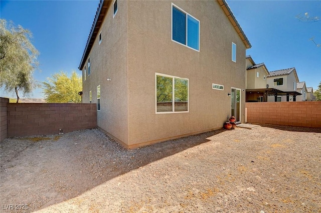 8164 Golden Cholla Ave, Las Vegas, NV 89179 - view of side of home with a fenced backyard and stucco siding