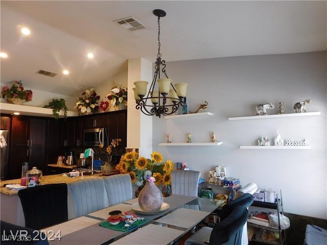 6201 E Lake Mead Blvd Unit 218, Las Vegas, NV 89156 - dining space featuring a chandelier and vaulted ceiling