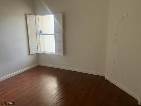 6201 E Lake Mead Blvd Unit 218, Las Vegas, NV 89156 - unfurnished room featuring dark wood-style flooring and baseboards
