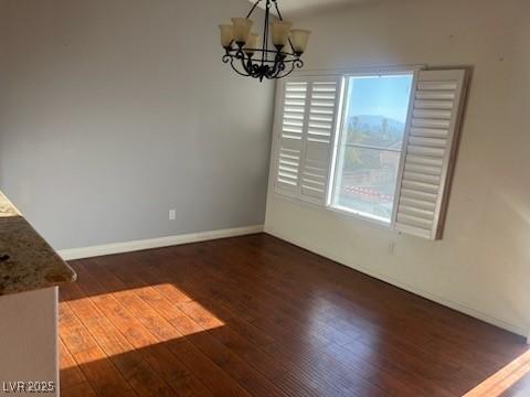 6201 E Lake Mead Blvd Unit 218, Las Vegas, NV 89156 - unfurnished dining area with hardwood / wood-style floors, a chandelier, plenty of natural light, and baseboards