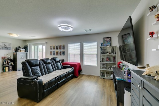 living area featuring light wood-type flooring and baseboards