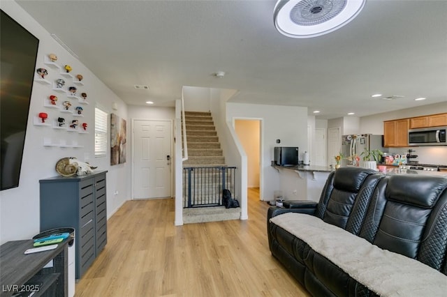 living area with light wood-style floors, recessed lighting, and baseboards