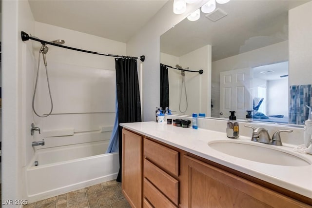 bathroom featuring vanity, shower / bath combination with curtain, and stone finish floors