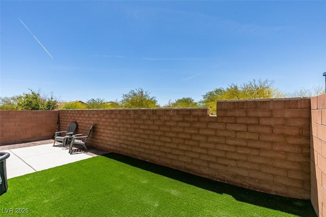 view of yard featuring a patio area and fence
