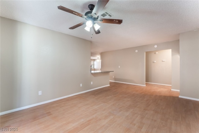 1729 Yellow Rose St, Las Vegas, NV 89108 - unfurnished living room with a ceiling fan, light wood-style floors, a textured ceiling, and baseboards