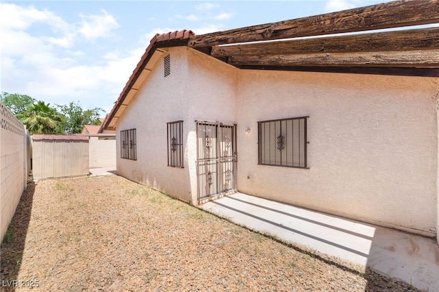1729 Yellow Rose St, Las Vegas, NV 89108 - back of property featuring stucco siding, fence, a storage shed, and an outbuilding