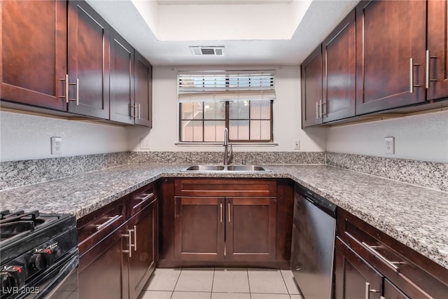 1729 Yellow Rose St, Las Vegas, NV 89108 - kitchen featuring a sink, stainless steel dishwasher, light tile patterned floors, range with gas cooktop, and a raised ceiling