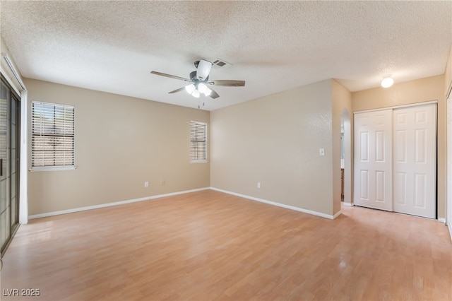 1729 Yellow Rose St, Las Vegas, NV 89108 - unfurnished bedroom with a textured ceiling, light wood-style floors, baseboards, and a ceiling fan