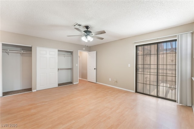 1729 Yellow Rose St, Las Vegas, NV 89108 - unfurnished bedroom with two closets, wood finished floors, a textured ceiling, baseboards, and ceiling fan