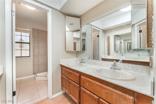 1729 Yellow Rose St, Las Vegas, NV 89108 - full bathroom featuring baseboards, double vanity, a shower stall, and tile patterned flooring