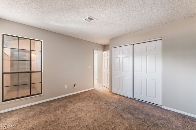 1729 Yellow Rose St, Las Vegas, NV 89108 - unfurnished bedroom featuring carpet flooring, baseboards, a textured ceiling, and a closet
