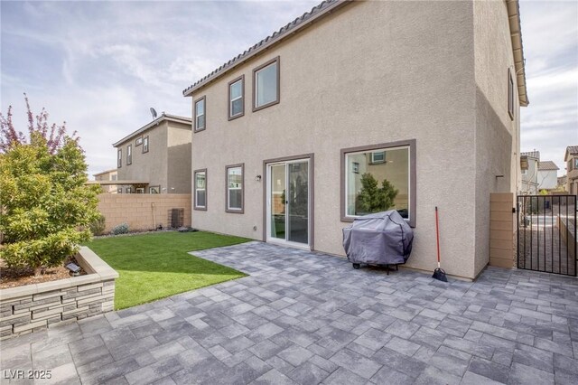 10376 Sadie Blake Ave, Las Vegas, NV 89166 - back of property featuring stucco siding, a patio area, and a gate