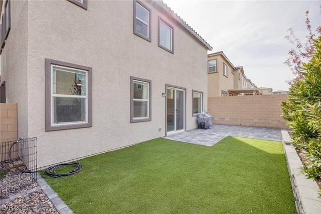10376 Sadie Blake Ave, Las Vegas, NV 89166 - back of property featuring stucco siding and a patio area
