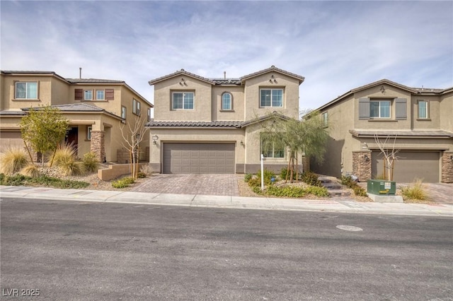 10376 Sadie Blake Ave, Las Vegas, NV 89166 - view of front facade featuring stucco siding, an attached garage, decorative driveway, and a tile roof