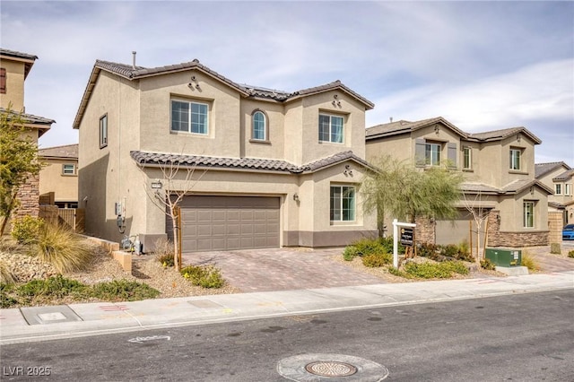 10376 Sadie Blake Ave, Las Vegas, NV 89166 - view of front facade with stucco siding, a tiled roof, an attached garage, and driveway