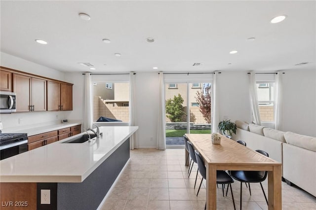 10376 Sadie Blake Ave, Las Vegas, NV 89166 - kitchen with a sink, stainless steel appliances, recessed lighting, light countertops, and brown cabinets